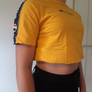 Champion t-shirt - Gul champion t-shirt. Nästan helt oanvänd! Storlek M för barn så passar en xxs-s beroende på hur man vill att den ska sitta. Frakt tillkommer.