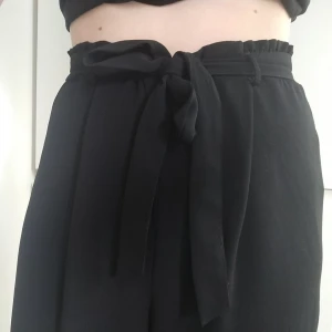 Flowy croppad byxa  - Världens skönaste byxa. Den är vid och flowy, croppad på vaden och man knyten den runt midjan. Vi delar på frakten ✨