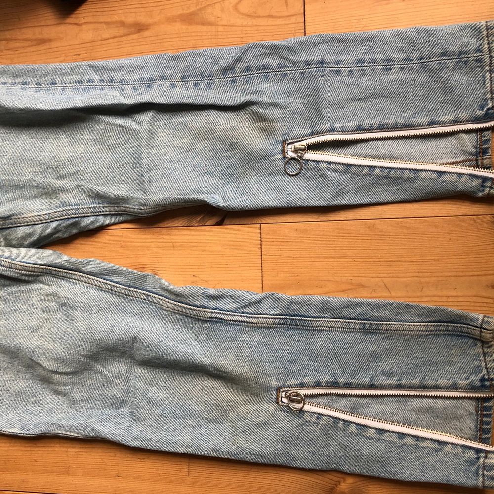 Ljusa jeans med slitsar/dragkedjor nedtill. Köparen står för frakt . Jeans & Byxor.