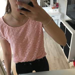 En rosa blommig T-shirt i storlek XS/S
