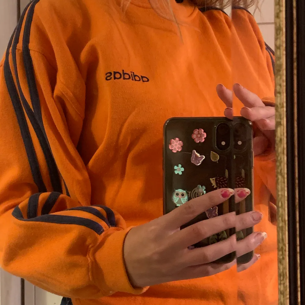 Cool adidaströja köpt secondhand i orange med blåa sträck, oklart vilken storlek det är men skulle gissa på M/L? . Tröjor & Koftor.