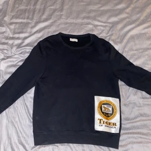 Tiger Of Sweden Sweatshirt Patch L - Säljer denna tröja då jag aldrig använder den. Köptes för ungefär 1 år sedan och den är i nyskick. Använt ca 10 ggr.                                                              Köptes för: 1099kr