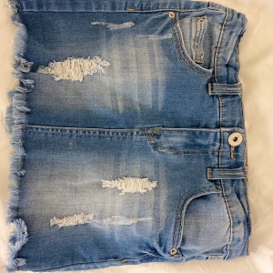 Jenas kjol - Blå Jenaskjol med slitningar från Kappahl. Storlek 140. Bra skick