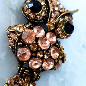 Det här haösbandet i guldfärg med svarta och rosa stenar är perfekt till den som vii liva upp sin outfit med en statement piece. Kontakta vid intresse😊. Frakt ingår👍😇