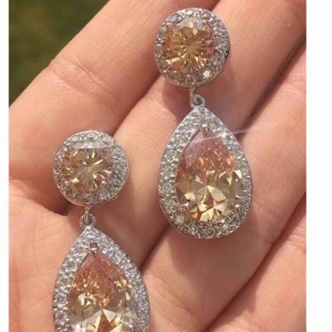 - Säljer nu dessa helt nya eleganta örhängena. Orange med klara stenar runt om i cubic zirkonia Längd: 3,6 x 1,5 cm Originalpris : säljes för ca 299-499:- beroende på vilken bröllops och festklänningsbutik man väljer.