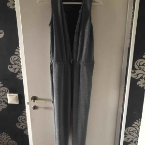  - Glitter jumpsuit with pockets and bottoms.