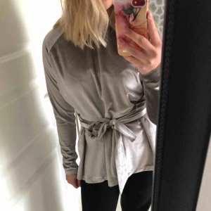  - Detta är en tröja med snörning runt magen. Ljus lila, lite metallic sammet och är ganska lång. Den sträcker sig ner till början av min rumpa och jag är ungefär 160cm. Har endast använts 2 gånger och är i mycket bra skick. 