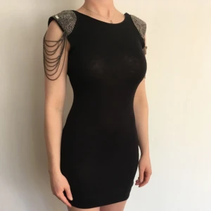  - I priset ingår frakt🌸 Skit snygg svart klänning från TopShop. Häftiga detaljer på axlarna med pärlor, kedjor ( allt helt ) i silver samt axelvaddar.  Storlek 34 men passar mig som är en 38.  Klänningen är lite noppig men inget som märks🌸