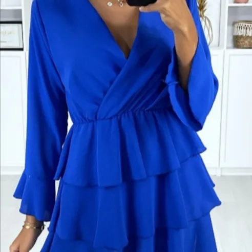 Long-sleeved crossover dress in royal with flounce at the bottom, 100% polyester. Klänningar.