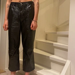 Lackimitationsbyxor  - Snygga, lite vidare byxor med lackimitation från NAKD i storlek 38 ⭐️ hon på bilden är 170cm och bär vanligtvis storlek S. Byxorna är normala i passformen. Köparen står för frakt men jag kan möta upp i närheten. 🌸