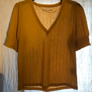 Gul topp - Gul topp med ett ”ribbat” material. Köpt på ullared för ungefär 1 år sedan men aldrig använd. Frakt ingår i priset! Passar upp till Storlek M