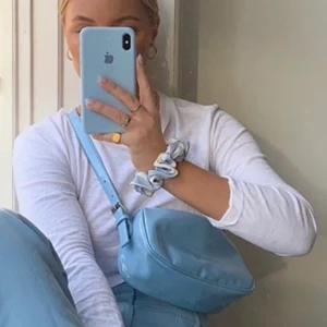 Blå axelväska  - Jättefin pastellblå axelväska från Nelly! I bra skick (endast använd fåtal gånger). Passar till allt, och rymmer mer än vad du tror! 