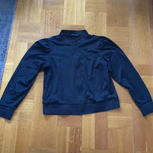 Rönnisch träningströja med puffaxlar strl. XL - Svart Rönnisch träningströja med puffaxlar i strl. XL. Pris exkl. frakt, köparen står för frakten.  