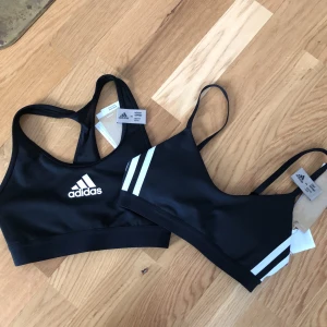 Adidas tops - 2 Adidas tops, new size XS. I sell cause I ordered the wrong size. AVAIBLE JUST THE ONE ON THE LEFT SIDE. Shipping included 