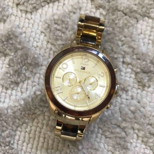  - HELT ÄKTA KLOCKA FRÅN HILFIGER.  Jättefint & unik klocka från Tommy Hilfiger.  Inköpt i Köpenhamn för några år sedan.  Klockan är i fint skick!   Perfekt present till student, födelsedag eller konfirmation.  (Obs: Behöver bytas batteri) 