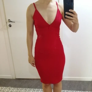Röd bodycon klänning  - Insydd vid midjan. Längd referens: 160cm 
