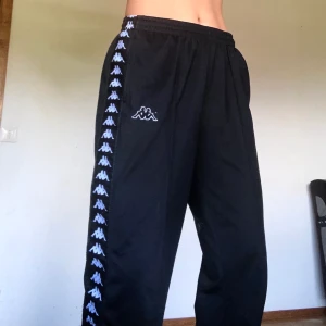 Kappa trackpants, strl M/L - Svarta trackpants från Kappa, strl M/L. Raka ben, jag är 175 cm. Nypris var 600kr. (Köparen står för frakt)
