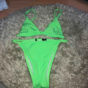  - Neon-grön bikini från Prettylittlething. Jättesnygg och gör att man ser brunare ut. Storleken är 6 vilket motsvarar 34/36. Underdelen känns större, passar mer 36. Aldrig använd, endast provad. Frakt: 30kr