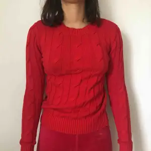 En röd stickad tröja från Gina Tricot. Kostar 100kr inklusive frakt.