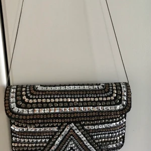 Kuvertväska från the moshi - Silverfärgad/bronsfärgad,  Mått i cm: 29x19