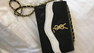 ysl hand/axelväska - superfin helt oanvänd väska i svart och vitt med guldiga detaljer. rymmer mycket. skriv vid intresse :)