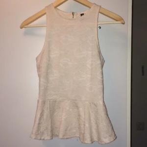  - Söt topp ifrån HM divided. Spetsigt tyg över ett skönt vitt lager. Härlig passform, med dragkedja bak. Använd men i bra skick! Köparen betalar frakt!