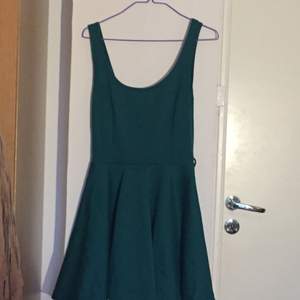 A green dress, length a bit over the knees, low scooped back 
