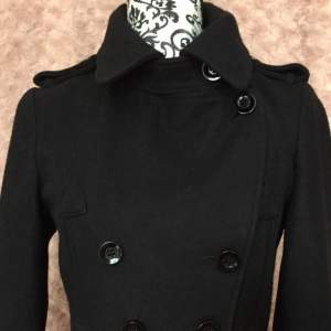 New black, double-breasted jacket from Top Shop. Size EUR38/UK10. Four pockets. Features such as lapels, with matching detail at back of waist as well as cuffs, give this little black jacket that something extra.