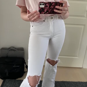 Vita bootcut jeans med hål - Säljer ett par skitsnygga vita bootcut jeans med hål på knäna 💖💖 jag är 167 och de passar perfekt! ingår frakt eller mötas upp i centrala Stockholm 🙌🏼🌸