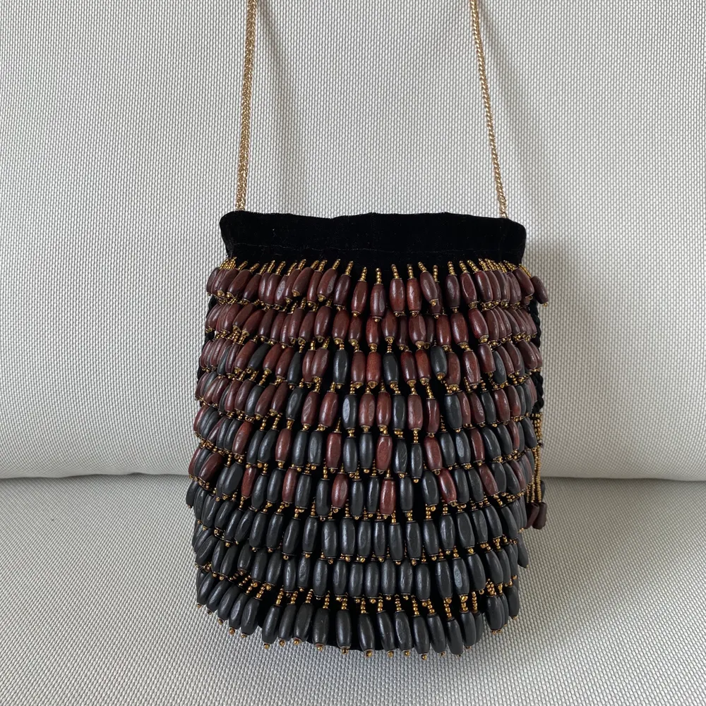 Zara black velvet beaded buck bag. Different colors wooden beads, golden chain shoulder strap. Rope tie closing. Excellent condition, never used. Väskor.