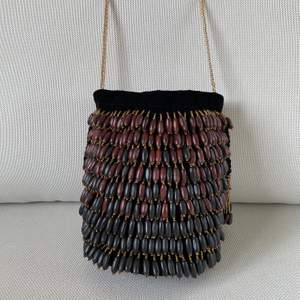 Zara black velvet beaded buck bag. Different colors wooden beads, golden chain shoulder strap. Rope tie closing. Excellent condition, never used