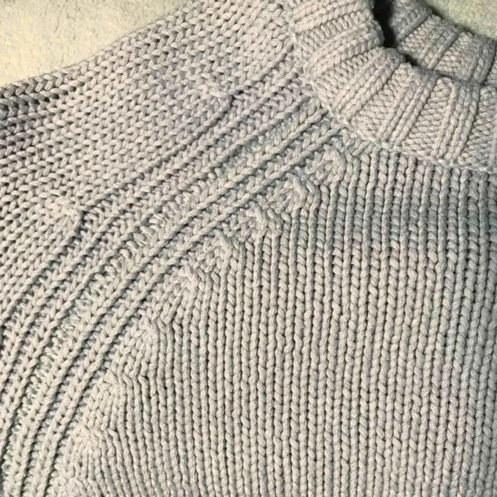 Stickad tröja i grå-blå färg med kabelstickade detaljer. 70% bomull. Nyskick, använd en eller två gånger. Köparen står för frakt alternativt möts upp i Uppsala! 🌞. Stickat.