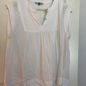 Tommy Hillfiger top - Vit topp Tommy Hillfiger, inköpt sommaren 2019. Använt men bra skick.