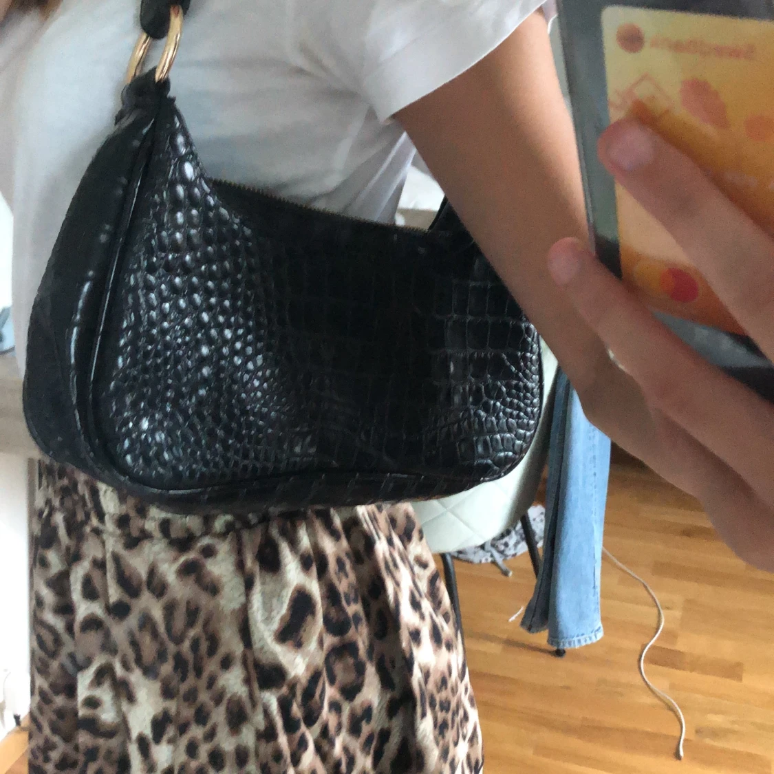 svart axelväska med krokodilmönster