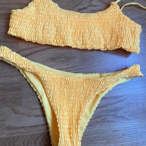 Bikini - En gul bikini som är mer åt de orangea hållet men fick inte fram det på bild! Trosorna ger den perfekta rumpan och färgen framhäver brännan! Storlek M men skulle säga att den är lite i storleken så mer som en S! Buda i kommentarerna, frakt 40kr