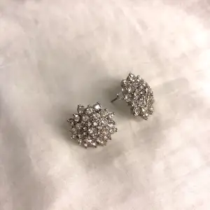 Fina silverfärgade örhängen med små kristalliknande pärlor. Frakt på 10 kr tillkommer.