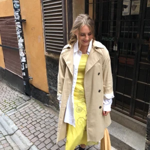 Vintage klänning ifrån Paris! - En tight, gul t-shirtklänning med 70-tals tryck. Använd ett fåtal gånger, i bra skick. Mjukt material och klänningen går till mitten av vaden på mig som är 168cm lång. 