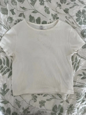 Vit t-shirt - En vit ribbad t-shirt från H&M i storlek M
