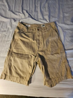 Lager 157 cargoshorts herr – stl 28 - Säljer cargoshorts från Lager 157 i herrstorlek 28. Praktiska och bekväma shorts med flera fickor, perfekta för sommar, vardag och fritid. Cargomodellen från Lager 157 har vanligtvis sidofickor på benen, bälteshällor och dragkedjegylf.