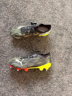 Puma ultra SG - Säljer ett par Puma Ultra fotbollsskor i snygg svart/grön design med gul och röd sula. Strl 42.  ✅ Mycket bra skick ✅ Helt nya ✅ Bra grepp (skruvdobbar) ✅ Lätta och bekväma  