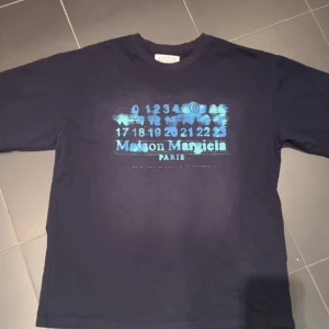 Maison Margiela Tshirt - Riktigt fet maison margiela tisha som säljs pågrund att den inte passa. Det är rare print som inte säljs längre och säljs för väldigt bra pris! Aldrig använd💯Priset är diskuterbart!