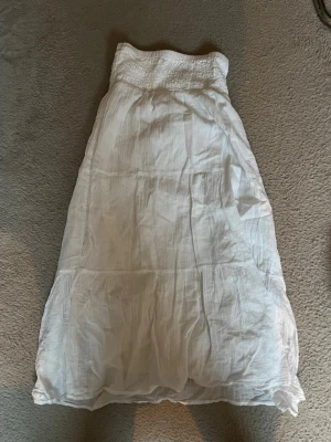 Vit långkjol i luftig bomull - TRYCK EJ KÖP DIREKT!!💗Snygg vit långkjol i luftig och lätt bomull med smock i midjan. Kjolen har en avslappnad passform och faller fint ner mot anklarna. Perfekt för varma dagar och enkel att matcha med olika toppar. Hör av dig vid intresse💗