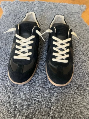 Black Maison Margiela GATs - Hey. Selling my Maison Margiela GATs in black . Size: 44 (fits TTS). Purchased from NK, 100% authentic. Great condition with original dust bags included. Message for more photos or proof of purchase