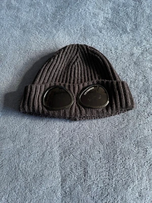 CP company mössa väldigt snygg zise one  - Cp company mössa skön och varm och snygg varsamt använd men den är grym. Ös på med frågor om ni vill och den är till för alla 