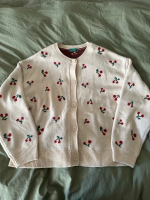 cherry knit cardi - bought in tokyo  used twice  it had some manufacturing flaws when i bought it, but they are not holes through the fabric!! (see two last photos) and it is not visible when wearing:)