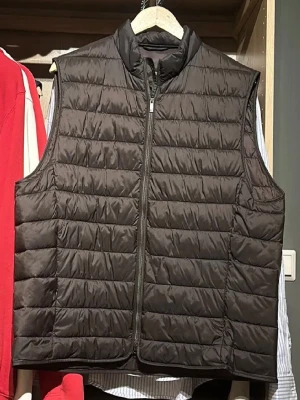 Brun dunväst från Bläck, XL - Snygg brun dunväst från Bläck i storlek XL. Västen har quiltad design, hög krage och dragkedja framtill. Perfekt för lager-på-lager och enkel att matcha med olika outfits. Tillverkad i lätt och smidigt material för extra komfort.