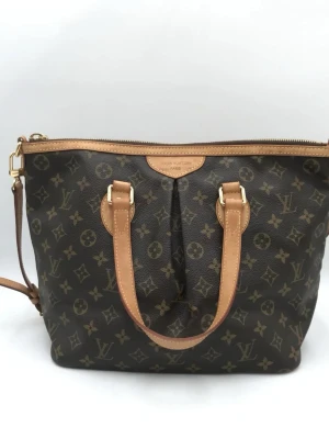 Louis Vuitton Monogram väska - Monogram Palermo PM Bag är inte bara en accessoar; den är ett uttalande om stil och sofistikering. Oavsett om du är en erfaren samlare eller en modeentusiast, är denna väska ett måste-ha-tillskott till din garderob. Missa inte möjligheten att äga en del av Louis Vuittons arv.