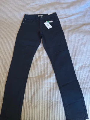 Svarta jeans The Rocker - Snygga svarta jeans från The Rocker i rak modell. Jeansen har klassisk femficksdesign och bälteshällor. Perfekta för dig som gillar en stilren look och vill ha ett par jeans som funkar till det mesta.