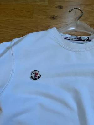 Moncler sweatshirt vit - Vit Moncler sweatshirt i mjukt och bekvämt material, perfekt för både vardag och avslappnade outfits. Klassisk design med stilren passform och Monclers ikoniska logga som ger en exklusiv känsla. PRIS KAN DISKUTERAS 