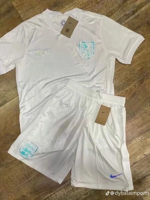 Vit England fotbollströja och shorts Nike - Säljer ett vitt fotbollskit från Nike med England-emblem på både tröja och shorts. Setet består av en kortärmad tröja och matchande shorts i lätt och ventilerande material. Båda plaggen har ljusblå detaljer och broderade loggor. Perfekt för träning eller match!